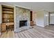 Inviting living area with a stone fireplace, built-in bookshelves, and elegant flooring, creating a cozy atmosphere at 1592 Boone Rd, Elon, NC 27244