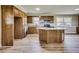 Charming kitchen with wood cabinets, stainless appliances, granite counters, and a breakfast bar island at 1592 Boone Rd, Elon, NC 27244