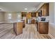 Spacious kitchen boasts wood cabinets, granite countertops, stainless steel appliances, and an island at 1592 Boone Rd, Elon, NC 27244