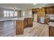Kitchen with wood cabinets, granite countertops, stainless appliances, and a large island at 1592 Boone Rd, Elon, NC 27244