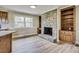 Living room featuring a stone fireplace and built in shelves along with hardwood floors at 1592 Boone Rd, Elon, NC 27244