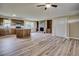 Open-concept living room featuring a fireplace, kitchen island, and hardwood flooring, perfect for entertaining at 1592 Boone Rd, Elon, NC 27244