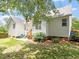 Charming back exterior with a small patio, lawn, and blossoming hydrangeas at 1662 Beechaven Rd, Fuquay Varina, NC 27526