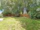 Large, grassy backyard enclosed by a wood fence and mature trees for privacy at 1662 Beechaven Rd, Fuquay Varina, NC 27526