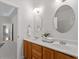 Bathroom featuring dual sinks, wooden cabinets, and a doorway leading to another room at 1662 Beechaven Rd, Fuquay Varina, NC 27526