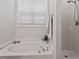 Bright bathroom featuring a soaking tub under a window and a separate shower stall at 1662 Beechaven Rd, Fuquay Varina, NC 27526