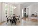 Cozy dining area features a modern chandelier and large windows bringing in lots of natural light at 1662 Beechaven Rd, Fuquay Varina, NC 27526
