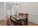 Elegant dining room with hardwood floors, wainscoting, and a stylish table at 1662 Beechaven Rd, Fuquay Varina, NC 27526