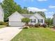 Charming single-story home with manicured lawn and inviting curb appeal at 1662 Beechaven Rd, Fuquay Varina, NC 27526