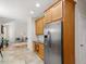 View of the kitchen area leading to the living room, with stainless steel refrigerator at 1662 Beechaven Rd, Fuquay Varina, NC 27526