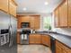 Updated kitchen boasts stainless appliances, ample counter space, and light oak cabinets at 1662 Beechaven Rd, Fuquay Varina, NC 27526
