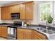 Featuring a functional kitchen with an updated stainless range and black microwave at 1662 Beechaven Rd, Fuquay Varina, NC 27526