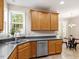 Kitchen featuring stainless steel dishwasher, undermounted sink and oak wood cabinets at 1662 Beechaven Rd, Fuquay Varina, NC 27526