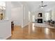 Open-concept living area with hardwood floors, fireplace, and dining area access at 1662 Beechaven Rd, Fuquay Varina, NC 27526