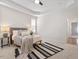 This large main bedroom features a tray ceiling and modern decor at 1662 Beechaven Rd, Fuquay Varina, NC 27526