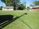 Lush green lawn and landscape with utility building and brick home providing a spacious outdoor setting at 1700 Warrenton Rd, Henderson, NC 27537