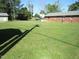 Expansive backyard with lush green lawn, utility building and brick home, perfect for outdoor enjoyment at 1700 Warrenton Rd, Henderson, NC 27537