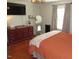Bedroom featuring hardwood floors, a large bed, and an ornate dresser, blending comfort with classic style at 1700 Warrenton Rd, Henderson, NC 27537