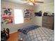 This bedroom is well-lit and features a plaid comforter, wooden floors, and pegboards used for decoration at 1700 Warrenton Rd, Henderson, NC 27537