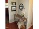 Welcoming entryway with stylish console table, decor, and warm wood flooring creates a cozy atmosphere at 1700 Warrenton Rd, Henderson, NC 27537
