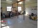 Expansive garage interior with concrete floors, equipped with workspaces, shelving, and tools, perfect for projects at 1700 Warrenton Rd, Henderson, NC 27537