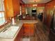 Bright, open kitchen leading to dining and living areas, all with matching hardwood floors at 1700 Warrenton Rd, Henderson, NC 27537