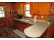 A well-lit kitchen featuring wood paneling, counter space, and modern appliances at 1700 Warrenton Rd, Henderson, NC 27537