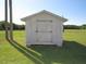 Outdoor shed with a rustic wooden door, set against a background of lush greenery at 1700 Warrenton Rd, Henderson, NC 27537