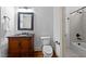 Elegant powder room with dark wood vanity, granite counter and black framed mirror at 1711 Happiness Hill Ln, Raleigh, NC 27614