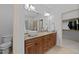 Bathroom showcasing double sinks with granite counters and a framed mirror at 1711 Happiness Hill Ln, Raleigh, NC 27614