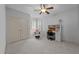 Bedroom with large windows, chair, ceiling fan, and desk, offering a comfortable and functional space at 1711 Happiness Hill Ln, Raleigh, NC 27614
