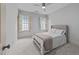 Bedroom features neutral walls, ceiling fan and window shutters, creating a serene atmosphere at 1711 Happiness Hill Ln, Raleigh, NC 27614