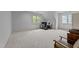 Spacious bonus room features windows, seating and desk area, offering ample space for activities at 1711 Happiness Hill Ln, Raleigh, NC 27614