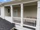Spacious covered porch with seating area and architectural details at 1711 Happiness Hill Ln, Raleigh, NC 27614