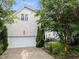 Home exterior featuring a garage, landscaped yard, and well-maintained siding at 1711 Happiness Hill Ln, Raleigh, NC 27614