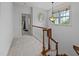Upstairs hallway with carpet, wood railing, and window letting in natural light at 1711 Happiness Hill Ln, Raleigh, NC 27614