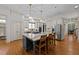 Open-concept kitchen with a large island, modern lighting, stainless steel appliances, and custom cabinetry at 1711 Happiness Hill Ln, Raleigh, NC 27614