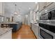 Spacious kitchen featuring a large island with seating, stainless steel appliances, and modern finishes at 1711 Happiness Hill Ln, Raleigh, NC 27614