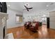 Open concept living room with hardwood floors adjoining dining and kitchen areas at 1711 Happiness Hill Ln, Raleigh, NC 27614