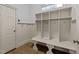 Bright mudroom features built-in storage cubbies, coat hooks and tiled floor at 1711 Happiness Hill Ln, Raleigh, NC 27614