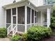 Charming screened porch with brick foundation and view of the backyard at 1711 Happiness Hill Ln, Raleigh, NC 27614