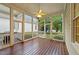 Spacious screened-in porch with wooden floors, ceiling fan, and views of the backyard at 1711 Happiness Hill Ln, Raleigh, NC 27614