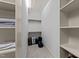 Walk-in closet with shelving and storage for clothes and accessories in a well-lit space at 1711 Happiness Hill Ln, Raleigh, NC 27614