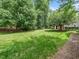 Expansive backyard featuring mature trees and well-maintained landscaping at 1911 Falls Landing Dr # 106, Raleigh, NC 27614