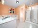 Bright bathroom featuring a large tub, shower, and double sinks at 1911 Falls Landing Dr # 106, Raleigh, NC 27614