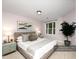 Comfortable bedroom with a large bed, natural light, and stylish decorations at 1911 Falls Landing Dr # 106, Raleigh, NC 27614