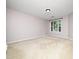 Spacious carpeted bedroom with a large window providing ample natural light at 1911 Falls Landing Dr # 106, Raleigh, NC 27614