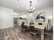 Well-lit dining area featuring modern lighting, stylish chairs, and hardwood flooring at 1911 Falls Landing Dr # 106, Raleigh, NC 27614