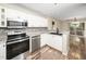Updated kitchen features stainless steel appliances, mosaic backsplash, and an undermount sink at 1911 Falls Landing Dr # 106, Raleigh, NC 27614