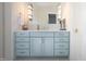 Bathroom vanity featuring blue cabinets, silver hardware, and a marble countertop at 2120 Kipawa St, Raleigh, NC 27607